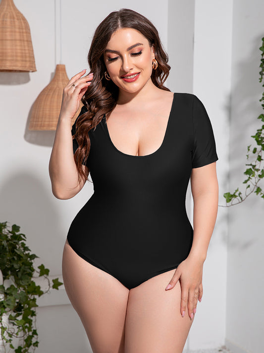 Trendsi plus size scoop neck swimsuit in black with short sleeves on a smiling model