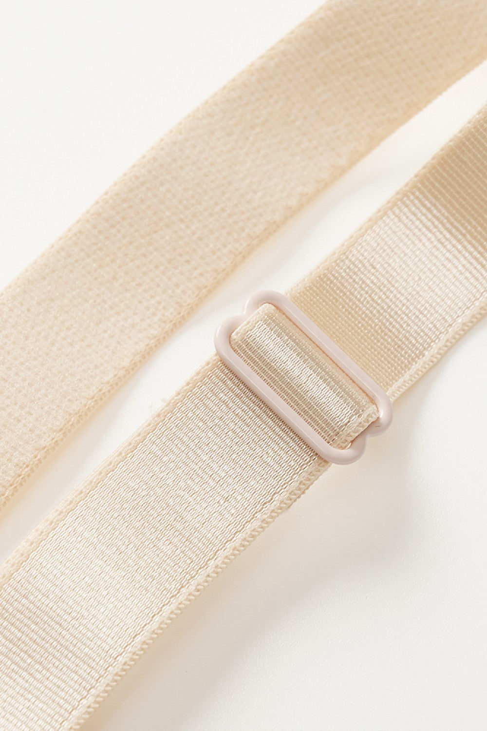 Beige adjustable strap detail of a plus size shapewear bodysuit from Trendsi