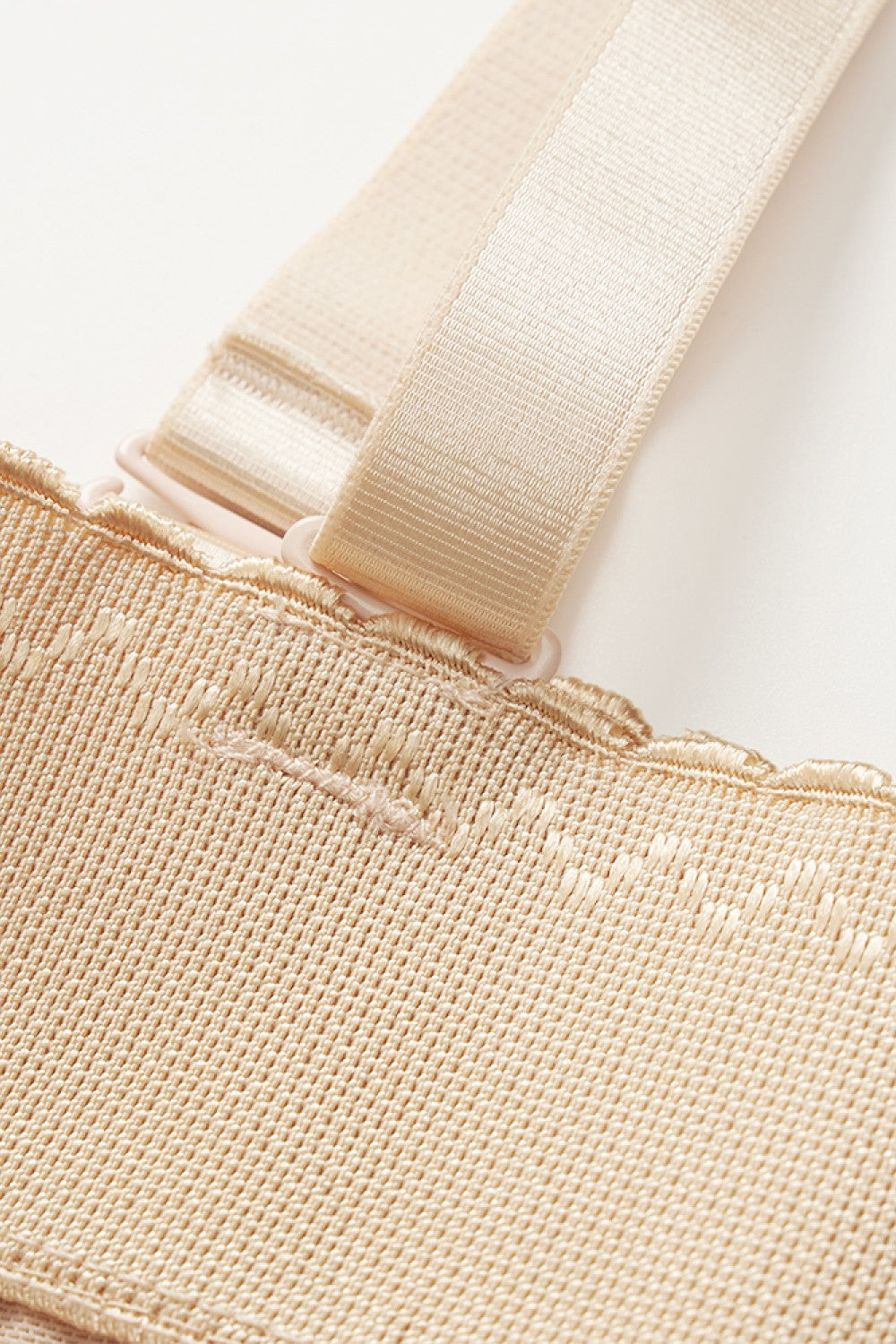 Close-up view of beige plus size shapewear bodysuit strap and stitching details