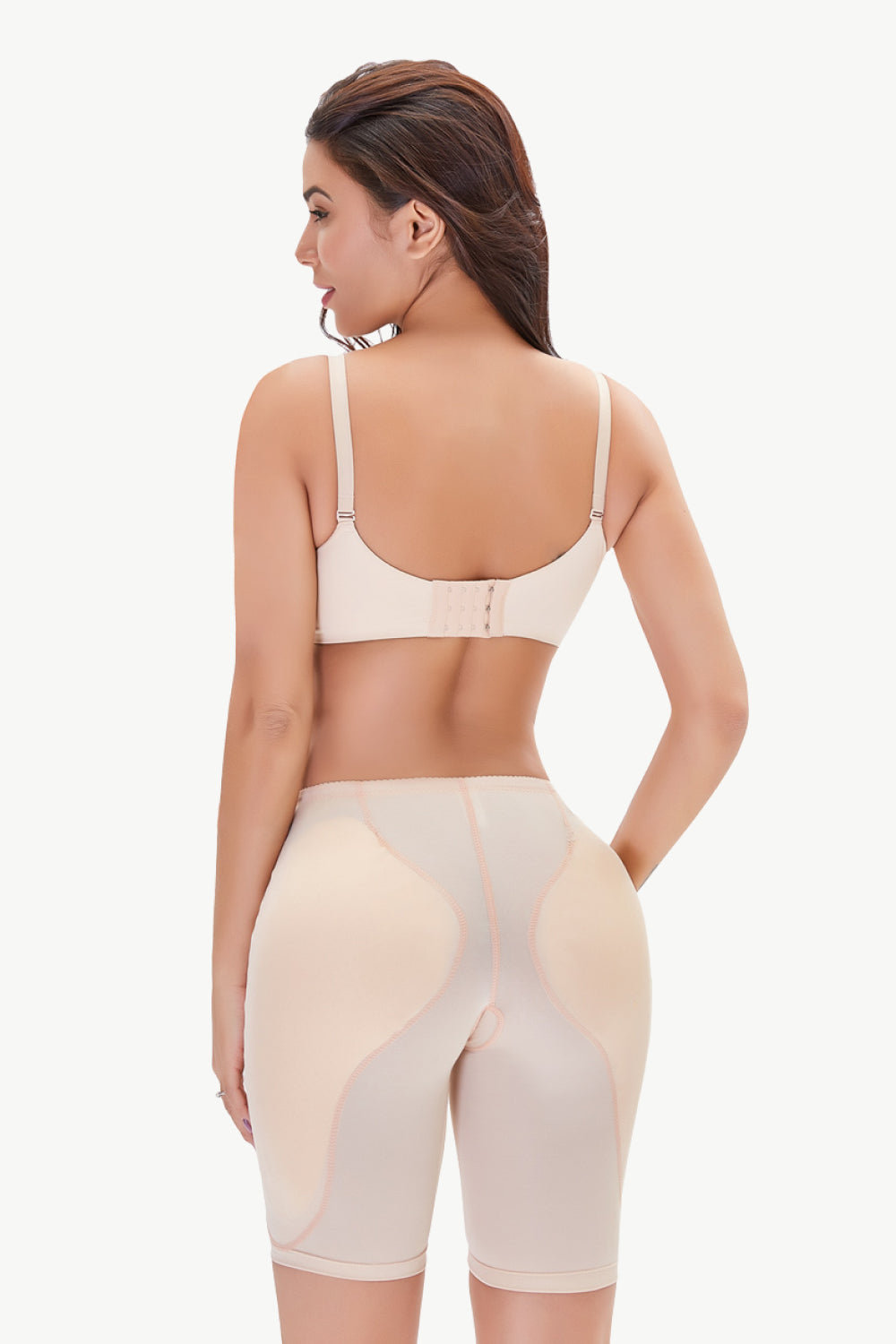 Trendsi plus size shaping shorts in nude color worn by model showing back view