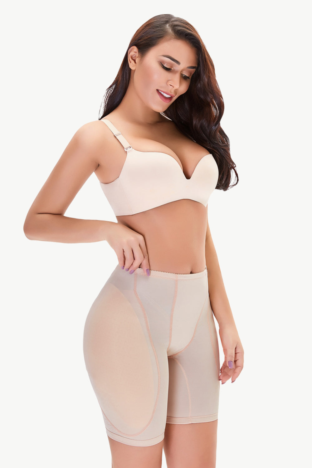 Woman wearing nude plus size shaping shorts with a matching bra for body contouring and support