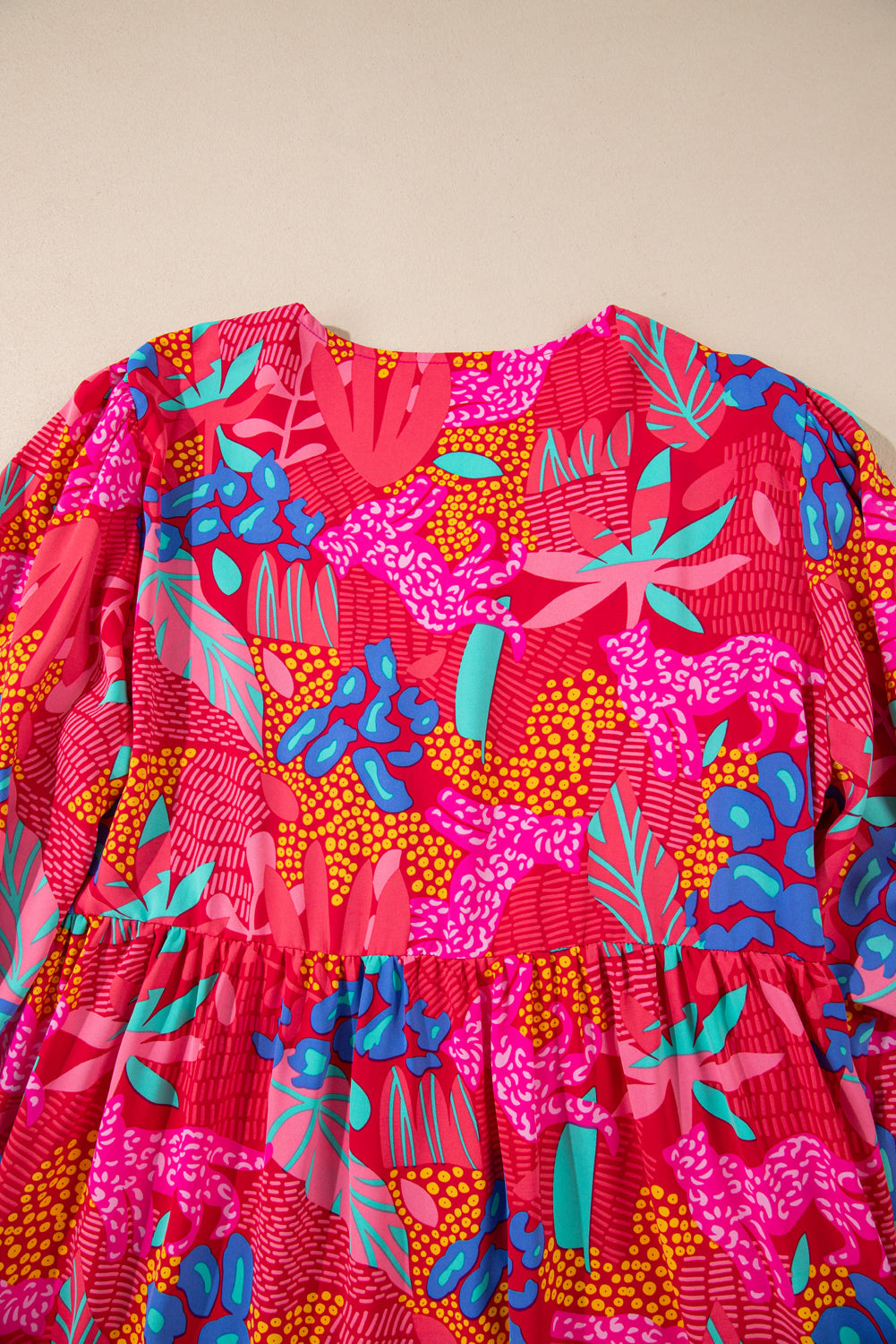 Bright plus size tropical print mini dress with vibrant pink, blue, and orange leaf patterns