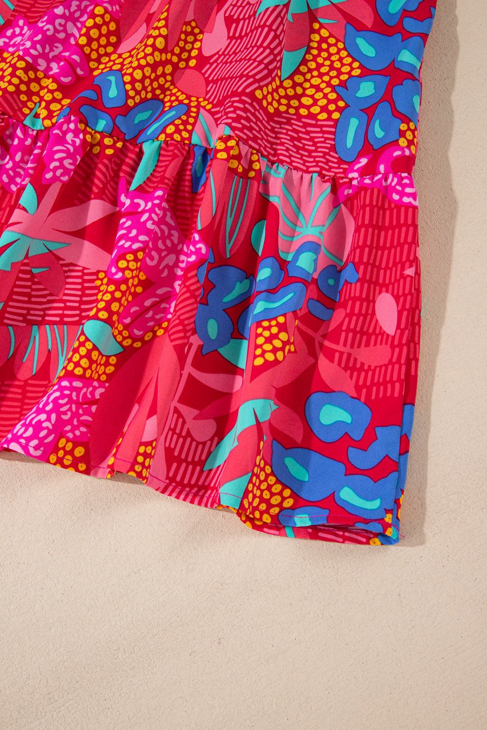 Close-up of vibrant plus size tropical print mini dress with colorful abstract floral patterns
