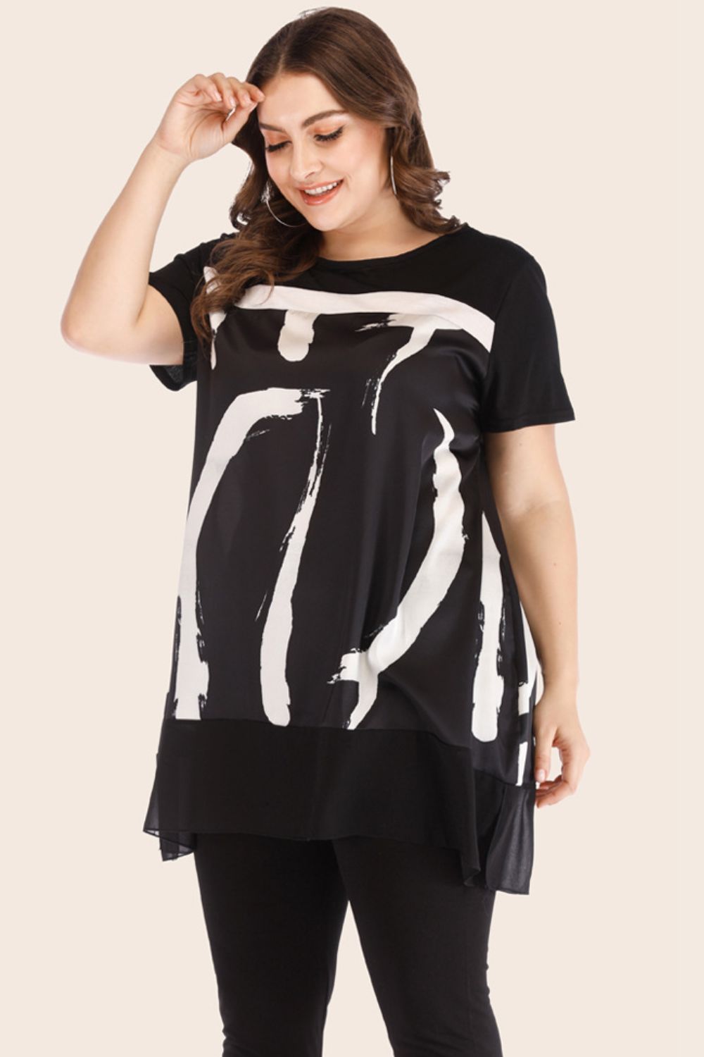 Plus size two piece lounge set featuring a black top with white abstract design and black leggings