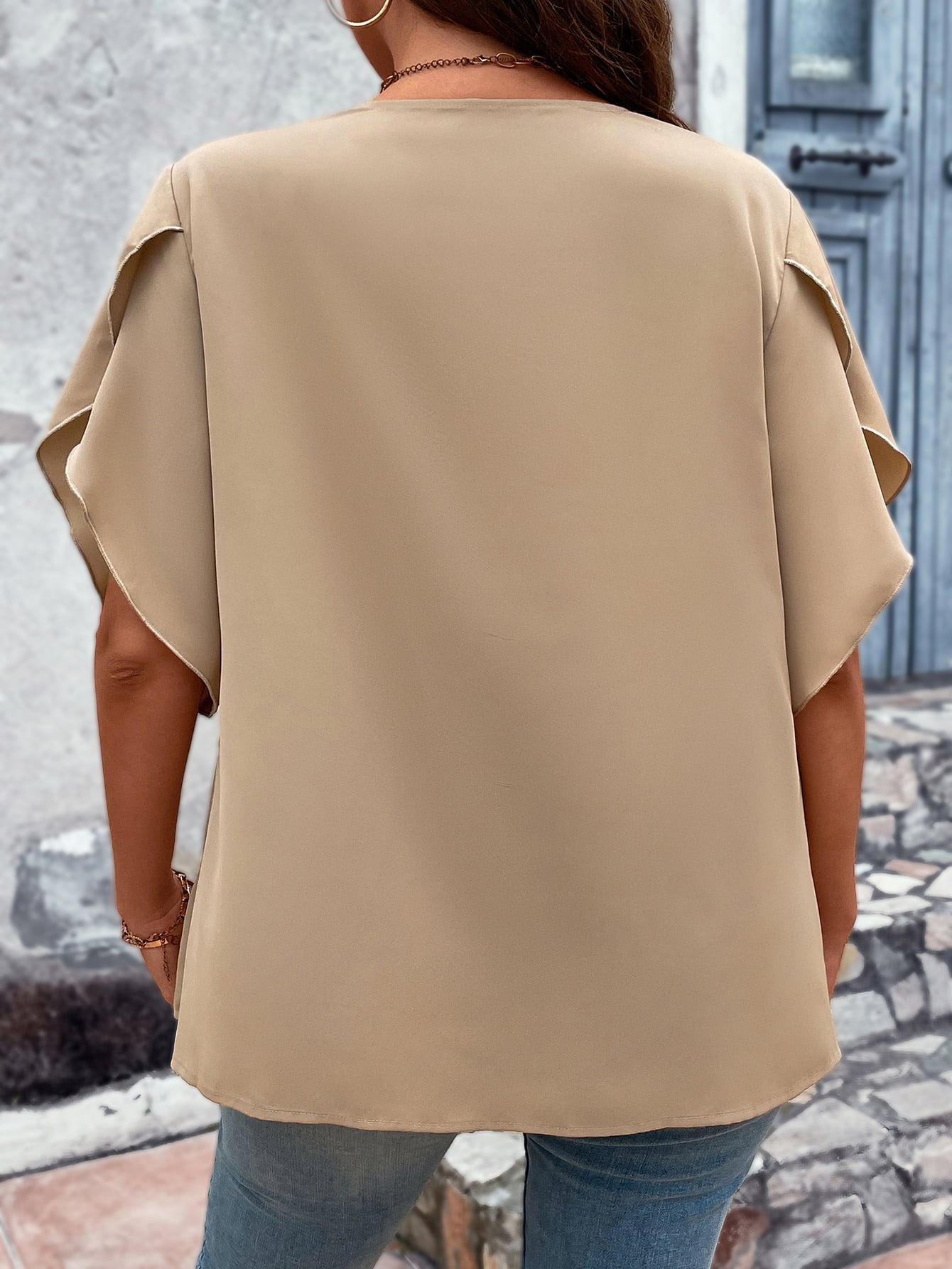 Back view of plus size v-neck blouse in beige with loose short sleeves and casual fit
