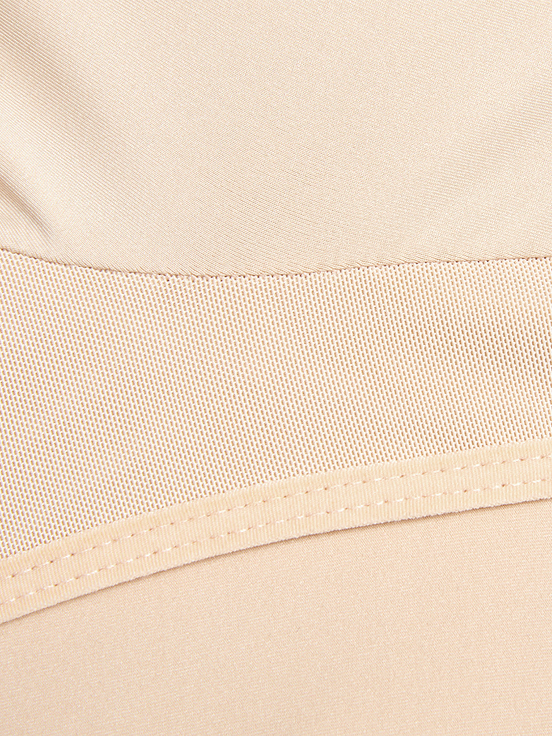 Close-up view of beige Trendsi plus size zip up shapewear fabric and stitching details