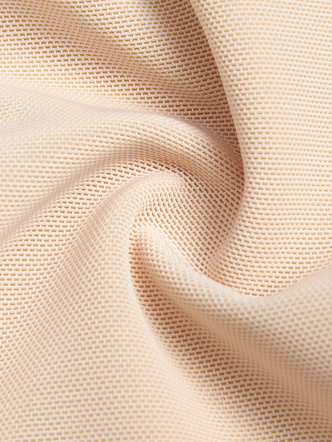 Close-up texture of beige fabric used in plus size zip up shapewear showing breathable mesh material