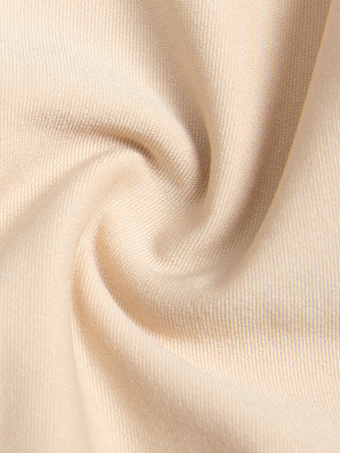 Close-up of beige fabric texture for plus size zip up shapewear by Trendsi