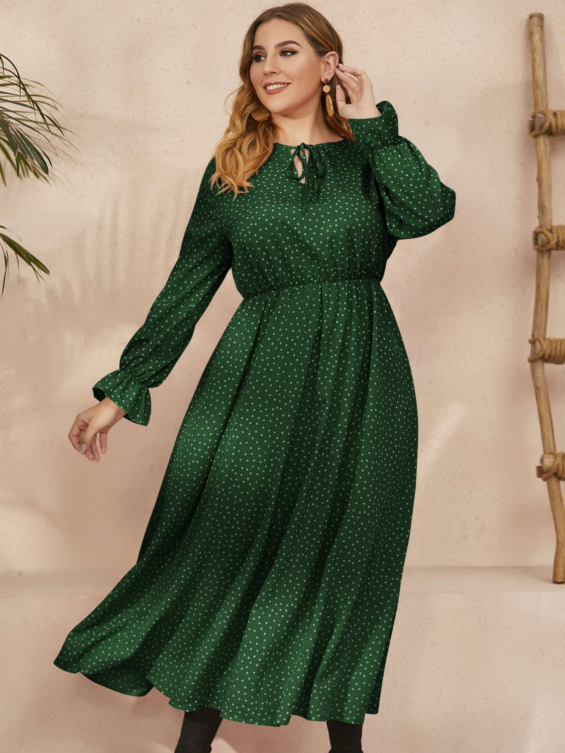 Plus size ruffled long sleeve dress in navy polka dot pattern with a flattering waist and comfortable fit