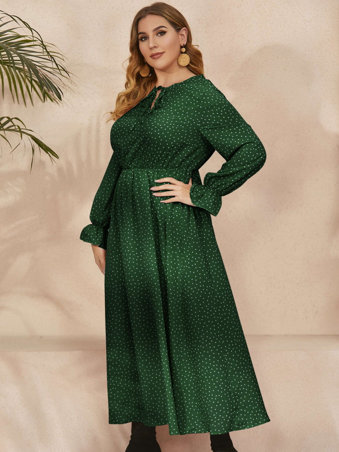 Honey Plus Size ruffled long sleeve maxi dress in navy polka dot pattern with a fitted waist and flowing skirt