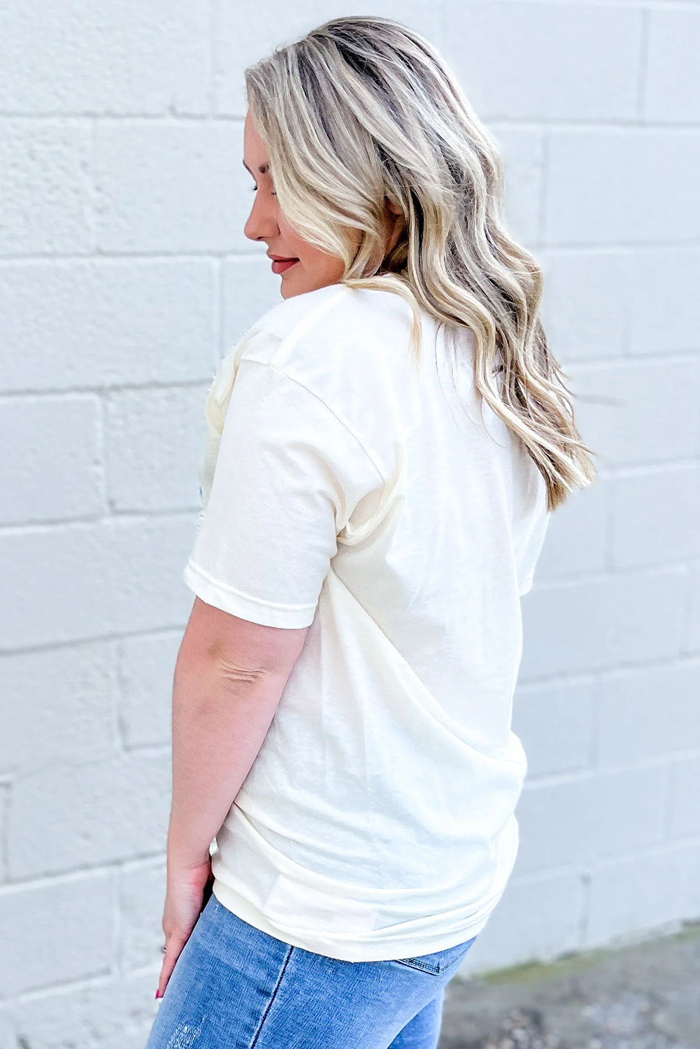 Woman wearing a sky blue USA graphic plus size tee from kjplussizefashion shown from the back