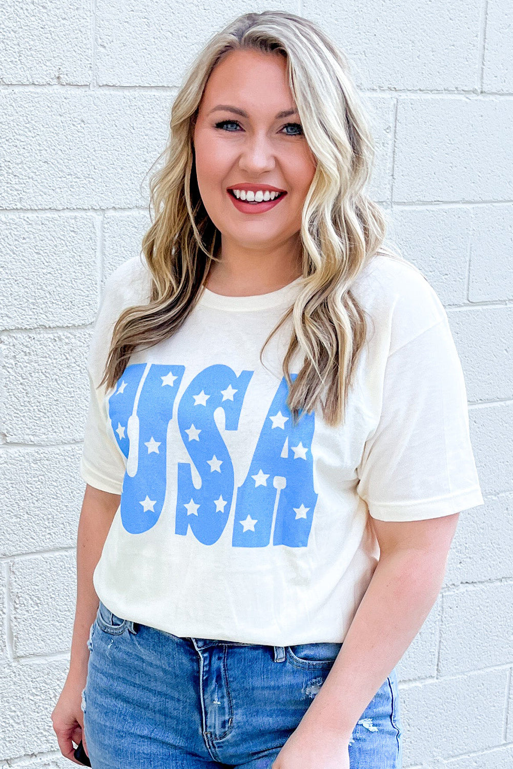 Model wearing sky blue USA graphic plus size tee with star design and casual denim jeans
