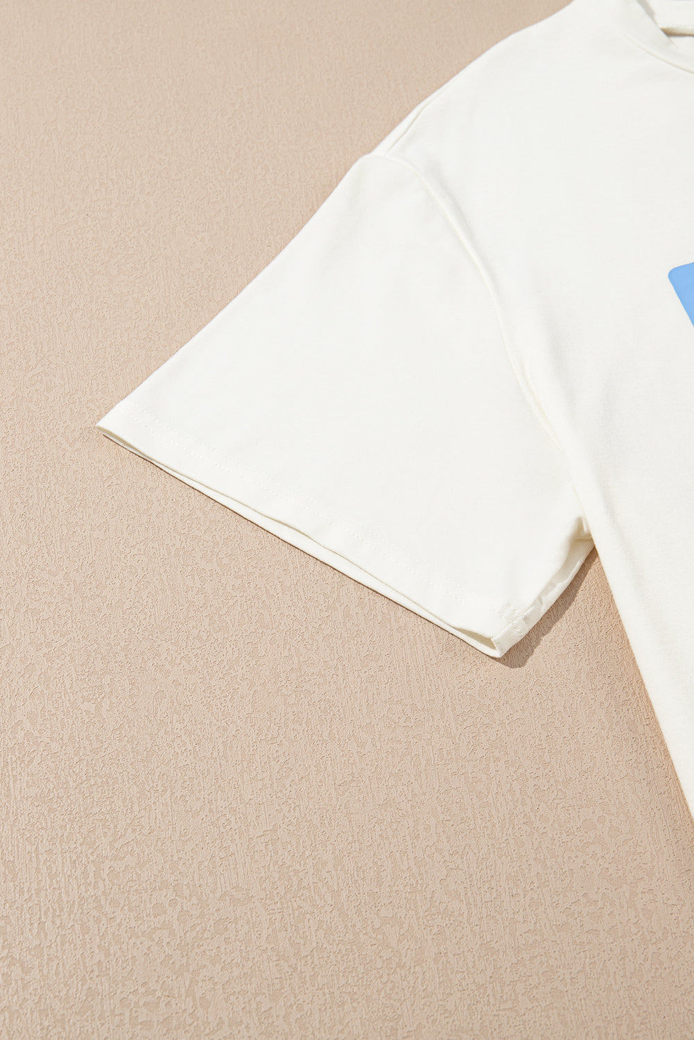 Close-up of short sleeve on sky blue USA graphic plus size tee by kjplussizefashion