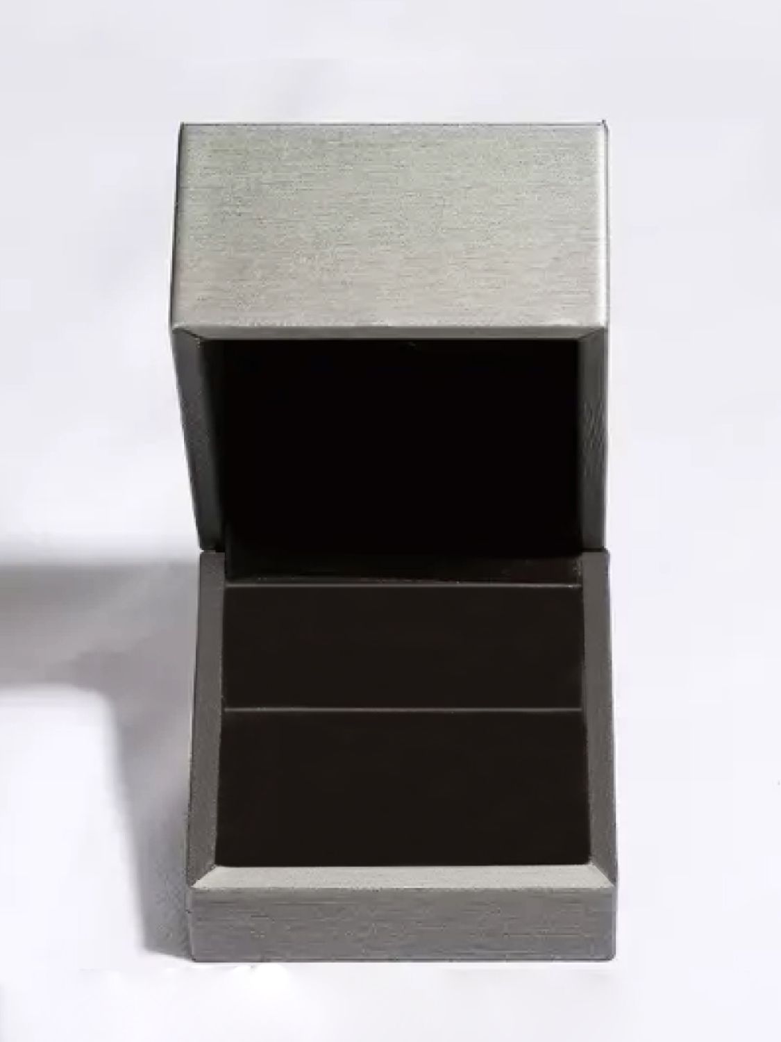 Empty silver jewelry box with black interior for sterling silver moissanite studs presentation