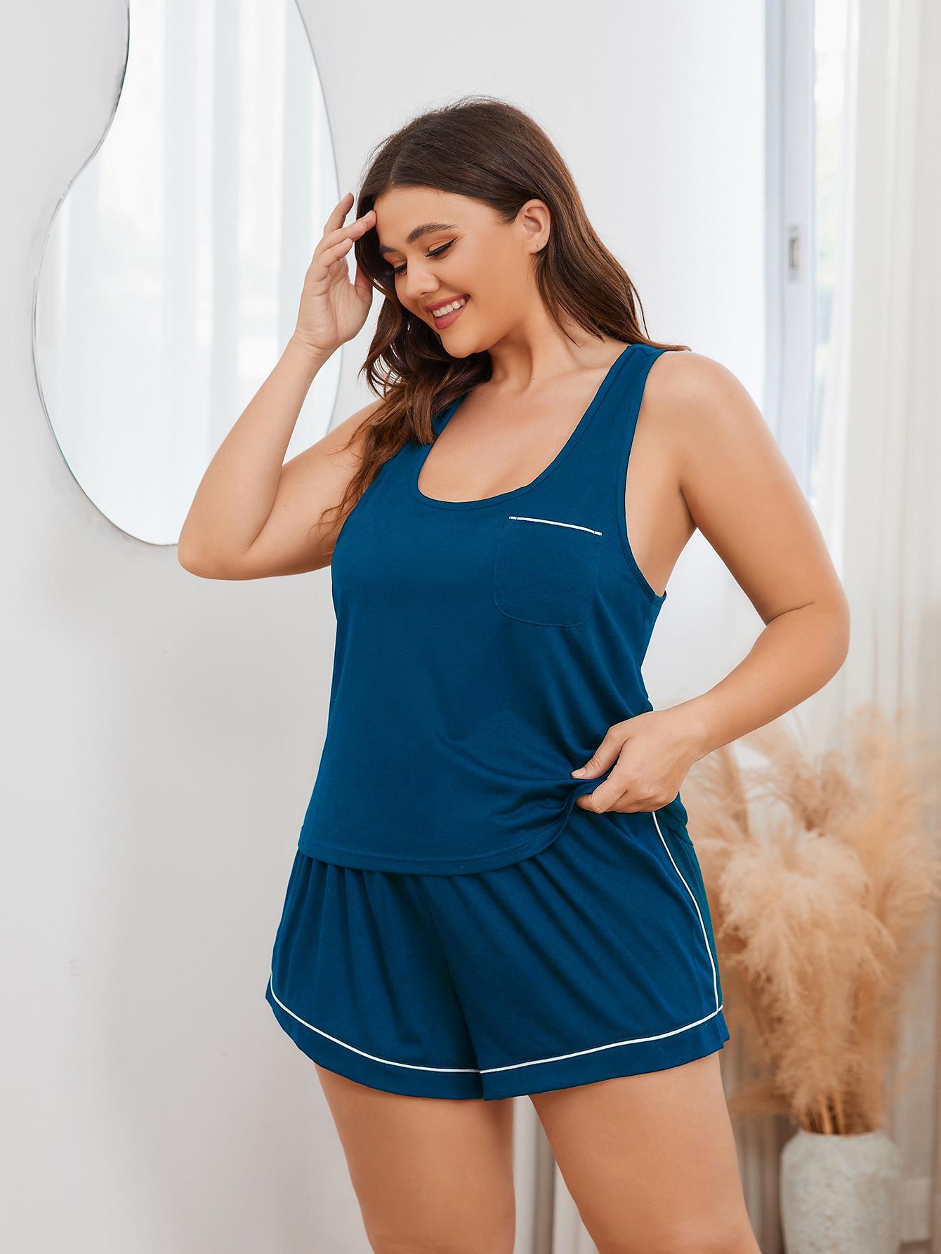 Trendy plus size sleepwear for women featuring a navy blue sleeveless top and matching shorts