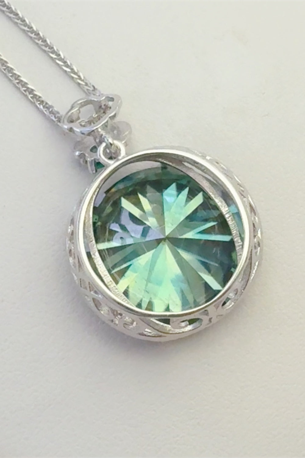 20 carat moissanite pendant necklace with round green gemstone set in silver filigree design