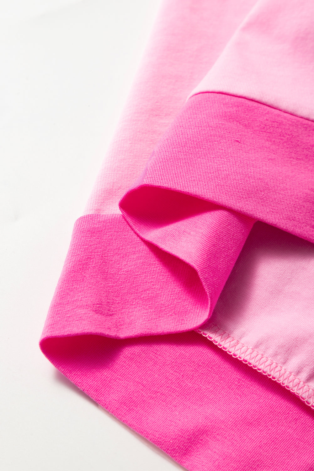 Bright pink short sleeve top for curvy women made of soft fabric with folded hem detail
