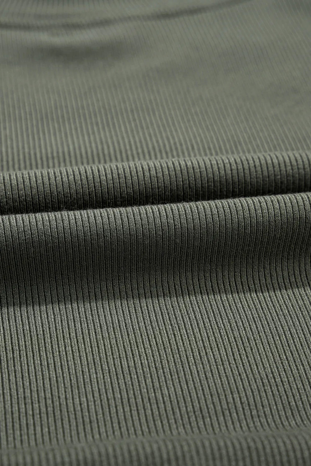 Close-up of ribbed fabric texture for casual plus size long sleeve blouse in olive green