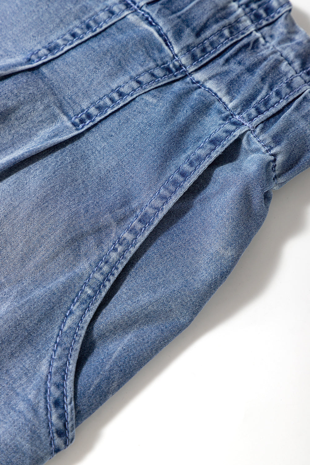 Close-up of blue denim comfortable plus size summer shorts with elastic waistband stitching