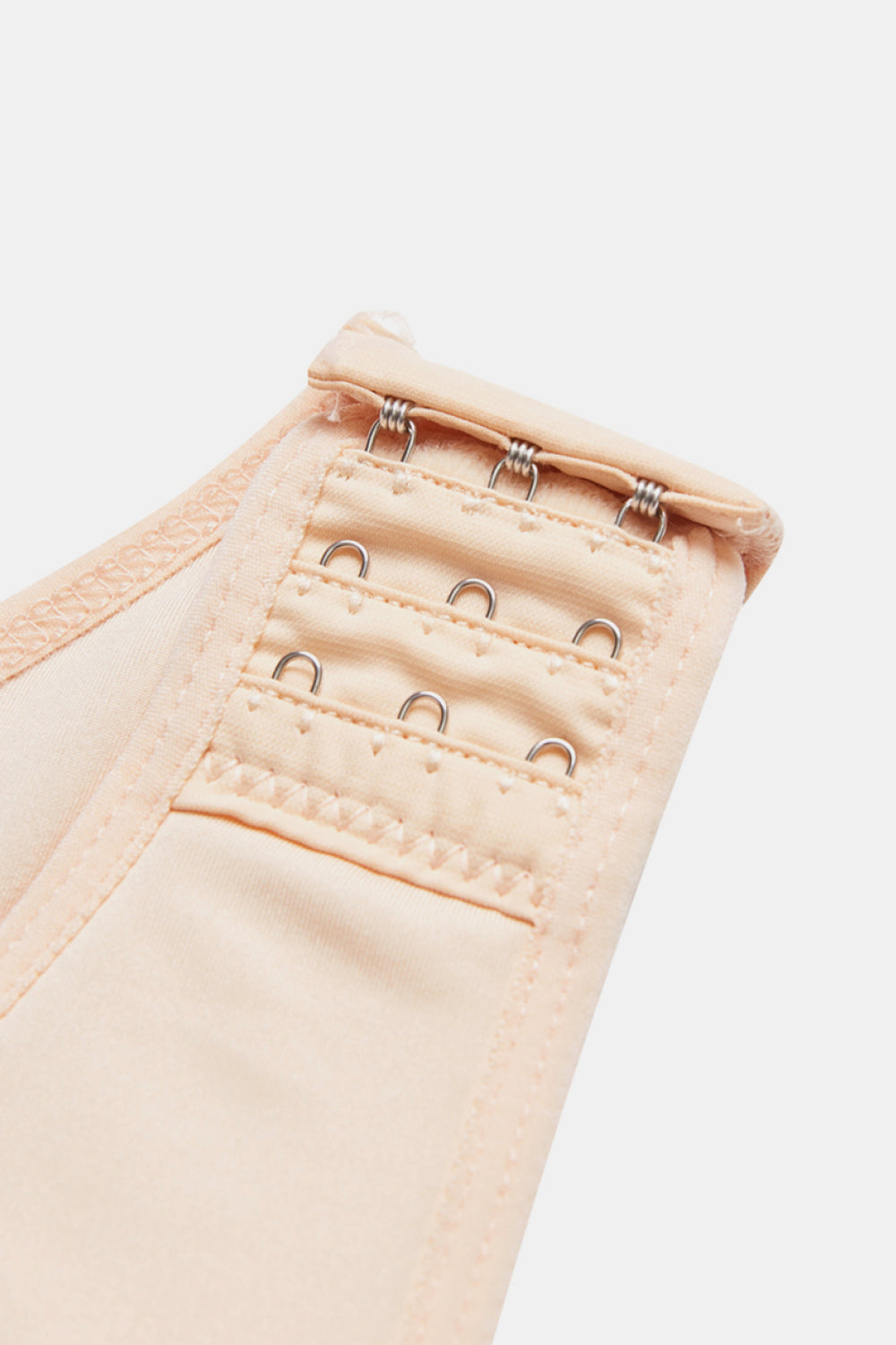 Beige full body plus size shapewear with adjustable hook and eye closure for a customized fit