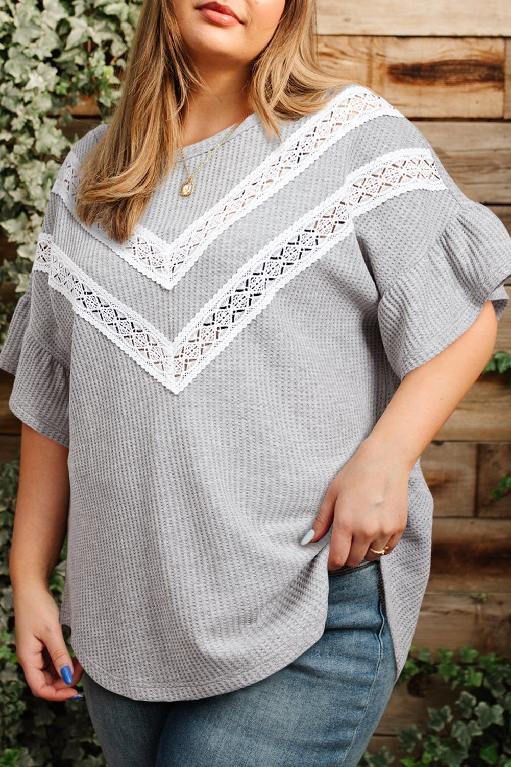 Plus size light grey ruffle sleeve blouse with white lace detail worn with blue jeans