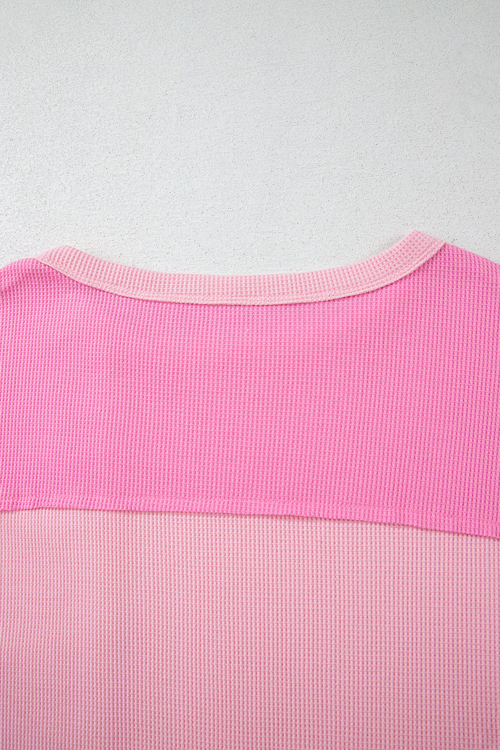 Close-up of pink stripe patchwork fabric detail on back of plus size summer shirt