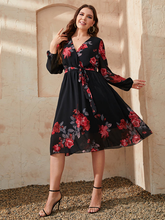 Trendsi plus size floral dress in black with red flowers, long sleeves, and a tie waist detail