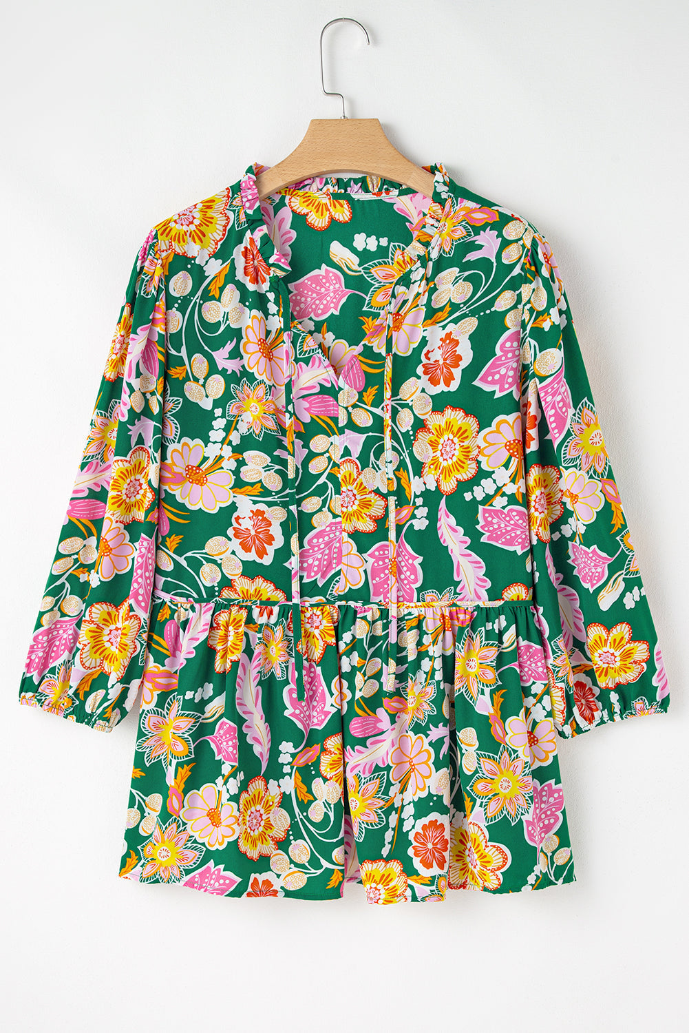 Plus size green floral tied babydoll top with long sleeves and flowy silhouette