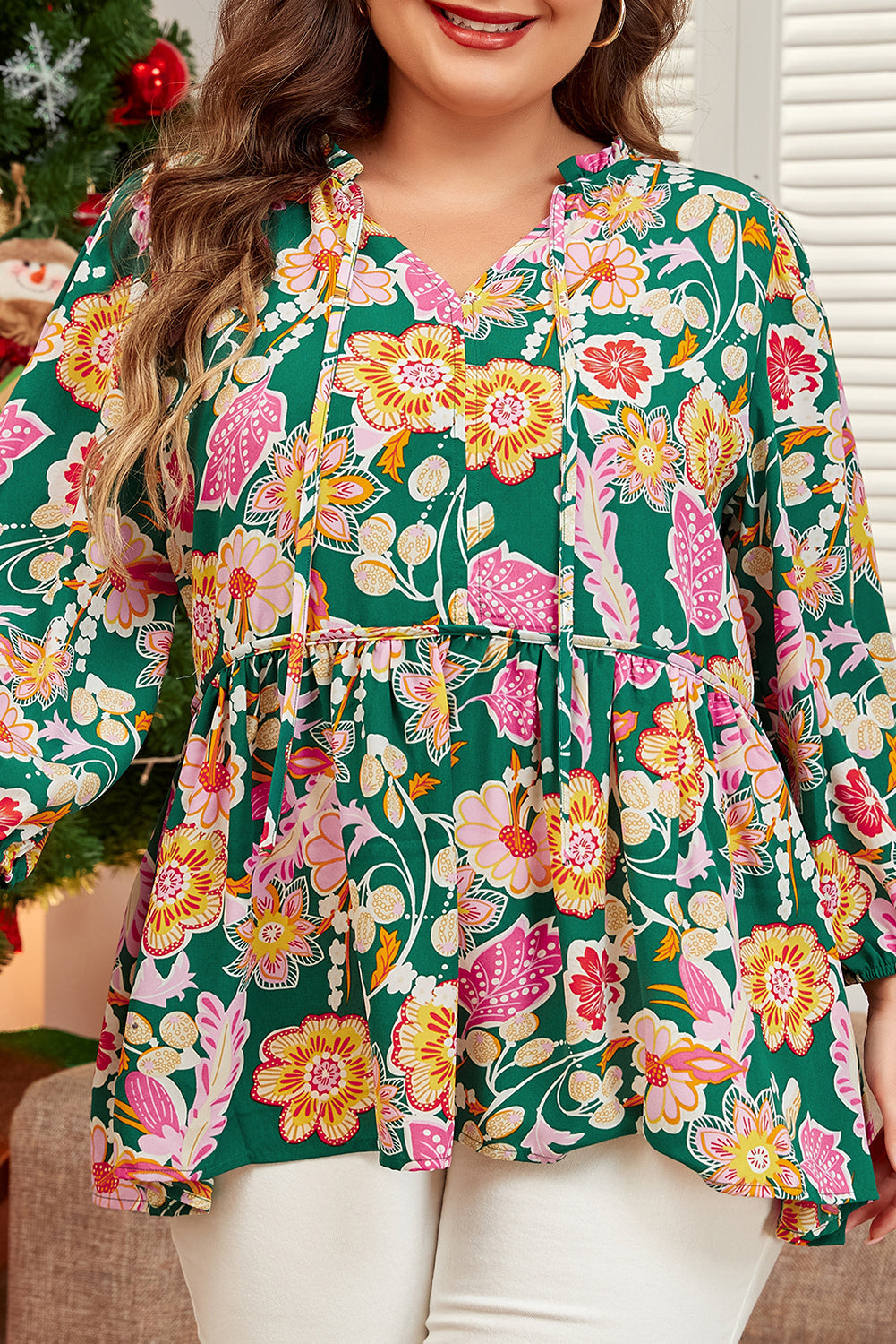 Plus size green floral tied V neck babydoll top with long sleeves and flowy silhouette
