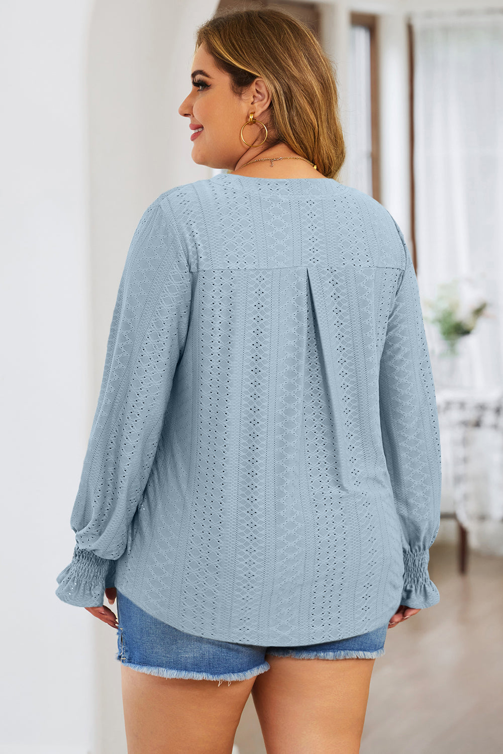 Plus size trendy blouse for women in light blue with long sleeves and textured pattern
