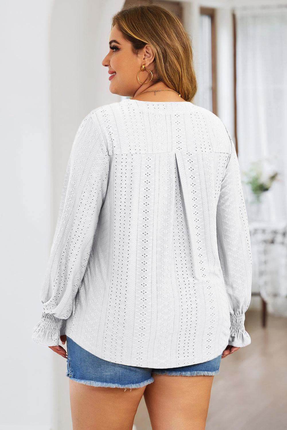 Plus size trendy blouse for women in white eyelet fabric with long sleeves and smocked cuffs