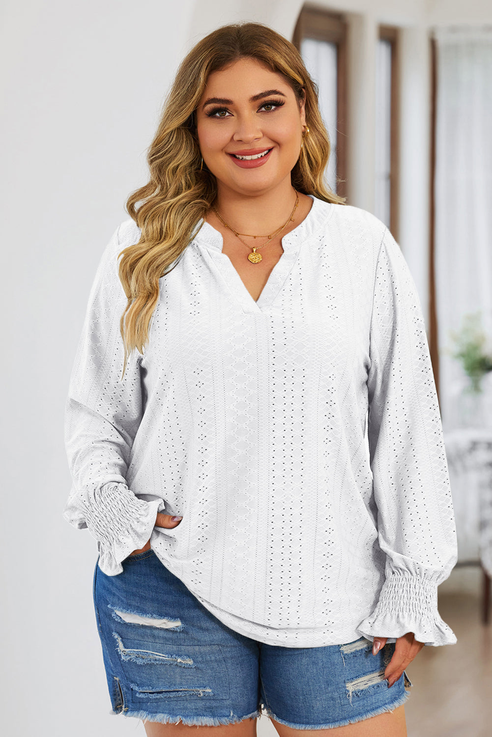 Plus size trendy blouse for women in white eyelet fabric with long sleeves and ruffle cuffs