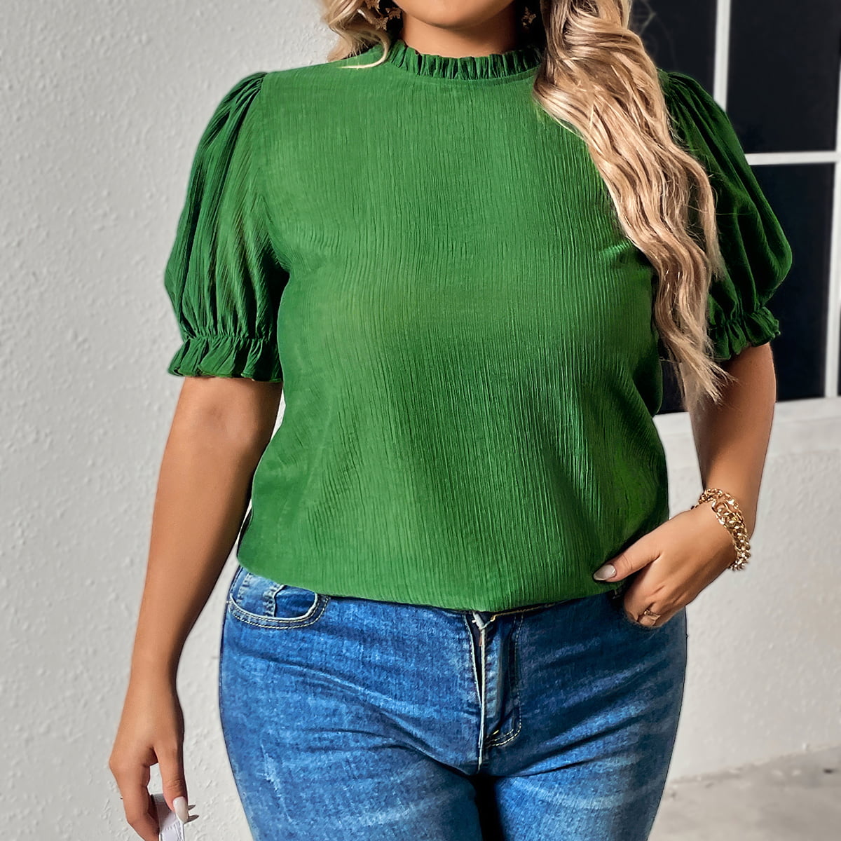 Green round neck plus size top for women with puff sleeves styled with blue jeans