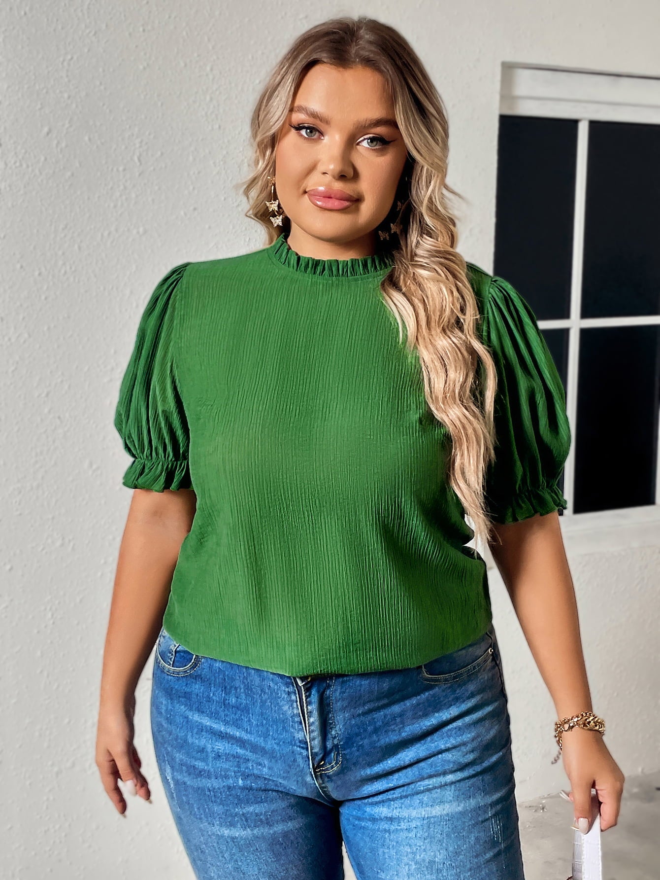 Green round neck plus size top for women with puff sleeves worn by model with long blonde hair