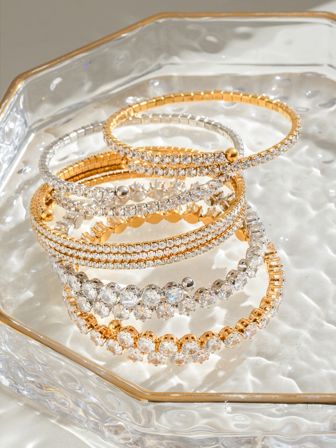 Trendsi stainless steel zircon bracelet set with gold and silver tones displayed on a glass dish