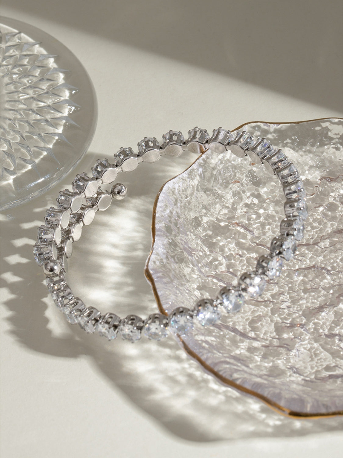 Trendsi stainless steel zircon bracelet with sparkling stones displayed on decorative glass dish