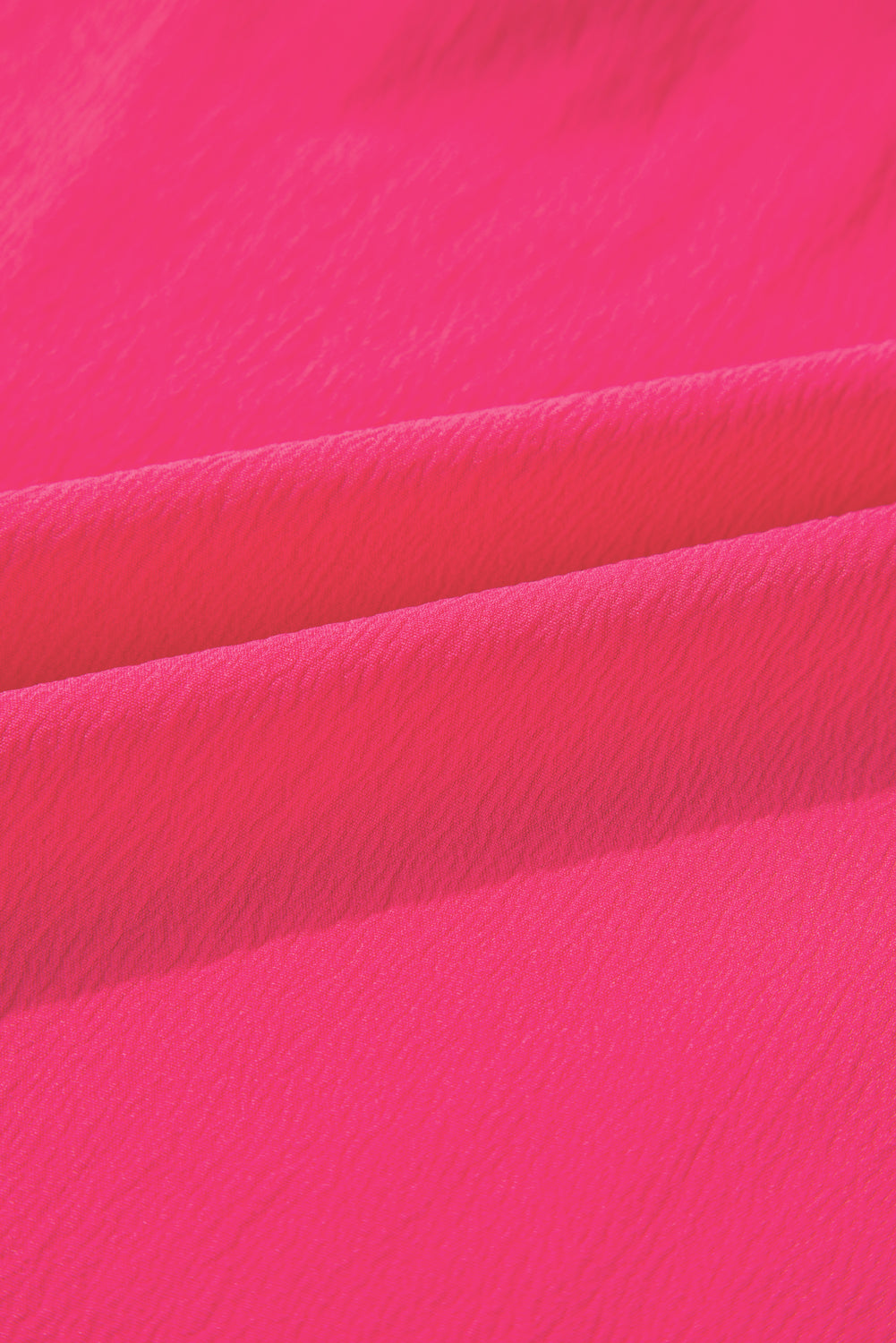 Close-up texture detail of strawberry pink embroidered blouse fabric from kjplussizefashion