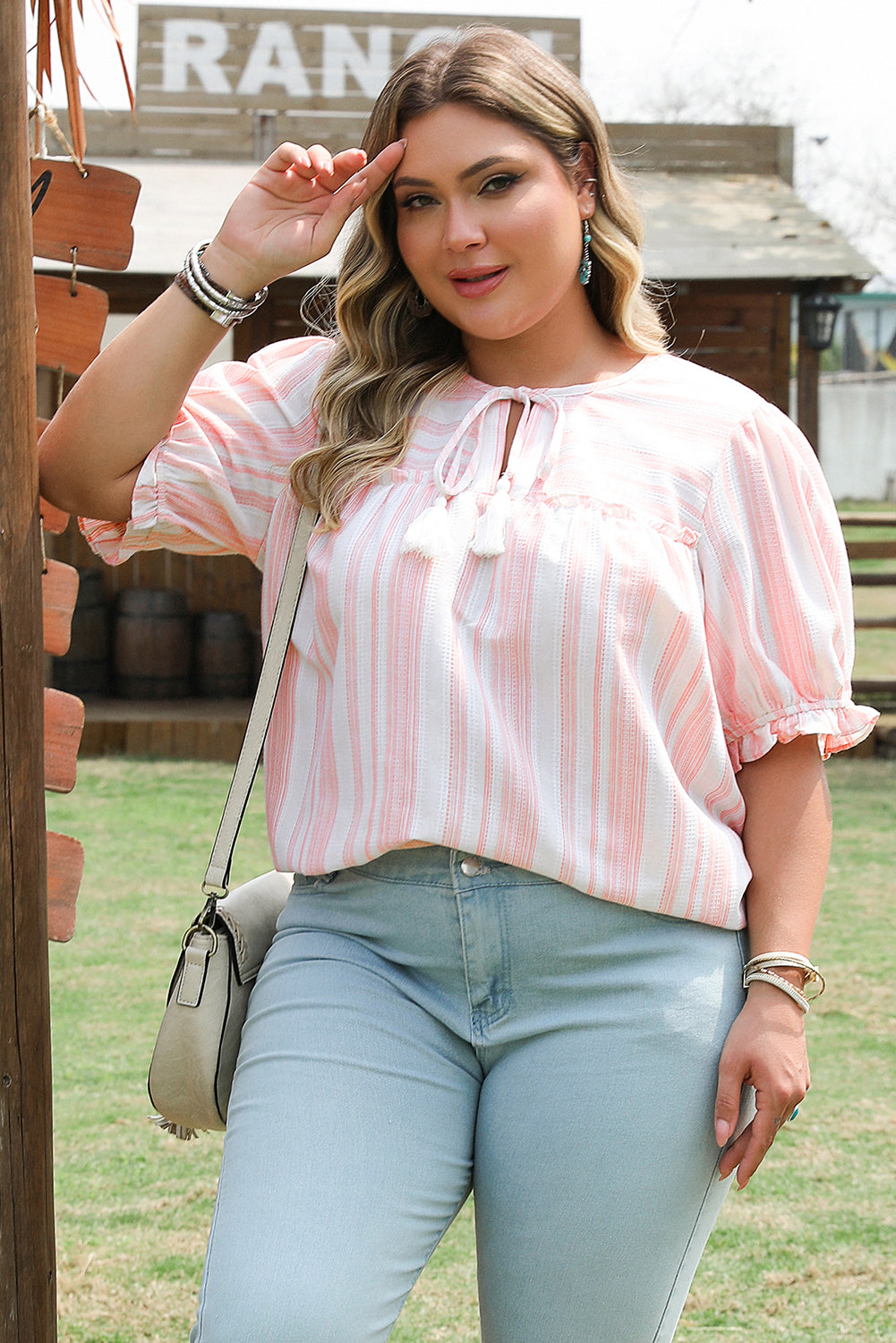 Tassel tie frilled sleeve top for curvy women in pink and white stripes styled with light blue jeans