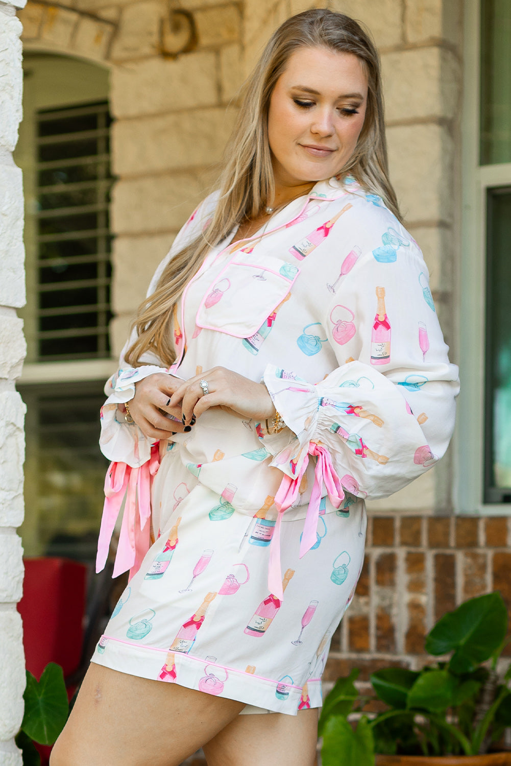 White bow knot sleepwear for curvy women featuring colorful bottle print and pink ribbon details