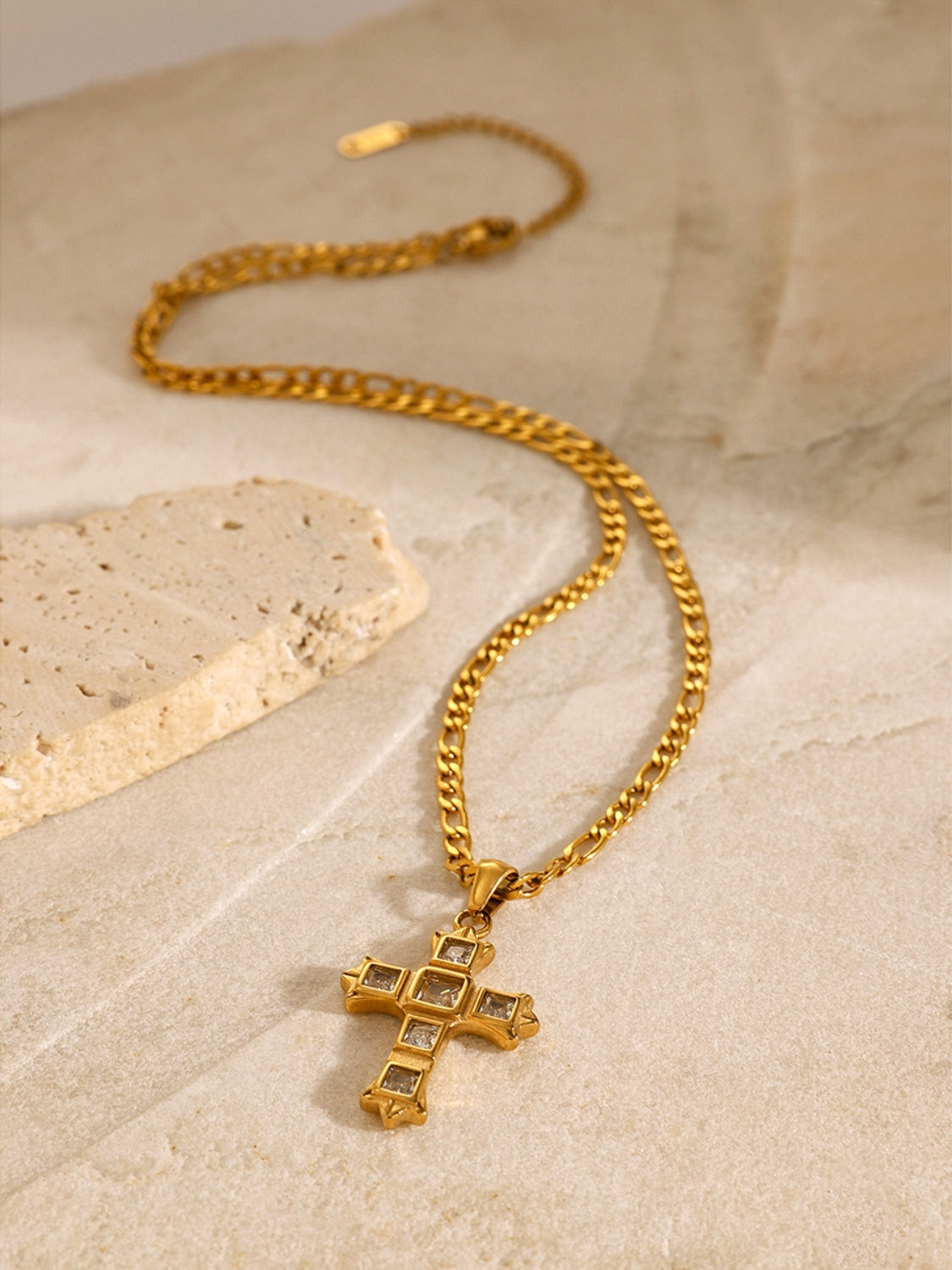 Trendsi gold chain necklace with zircon cross pendant for women displayed on stone surface
