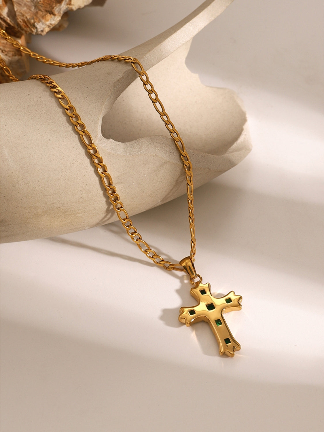 Zircon cross pendant for women in gold tone on a chain by Trendsi displayed on a neutral background