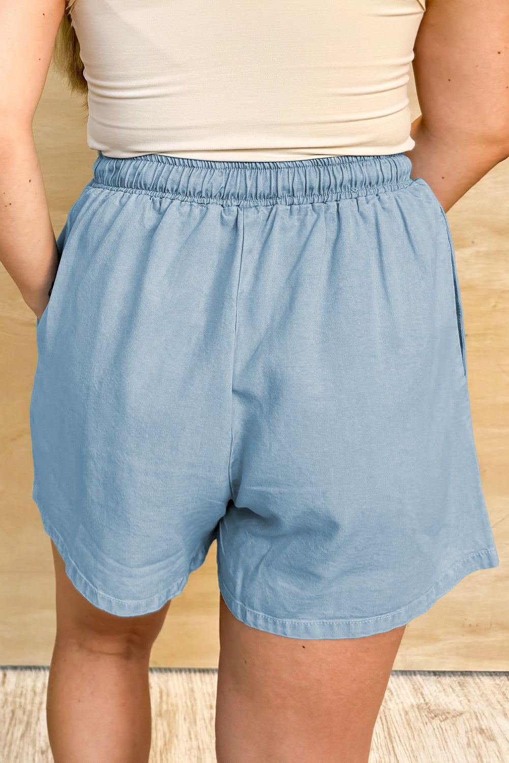Light blue elastic waist plus size summer shorts with a relaxed fit worn by a woman
