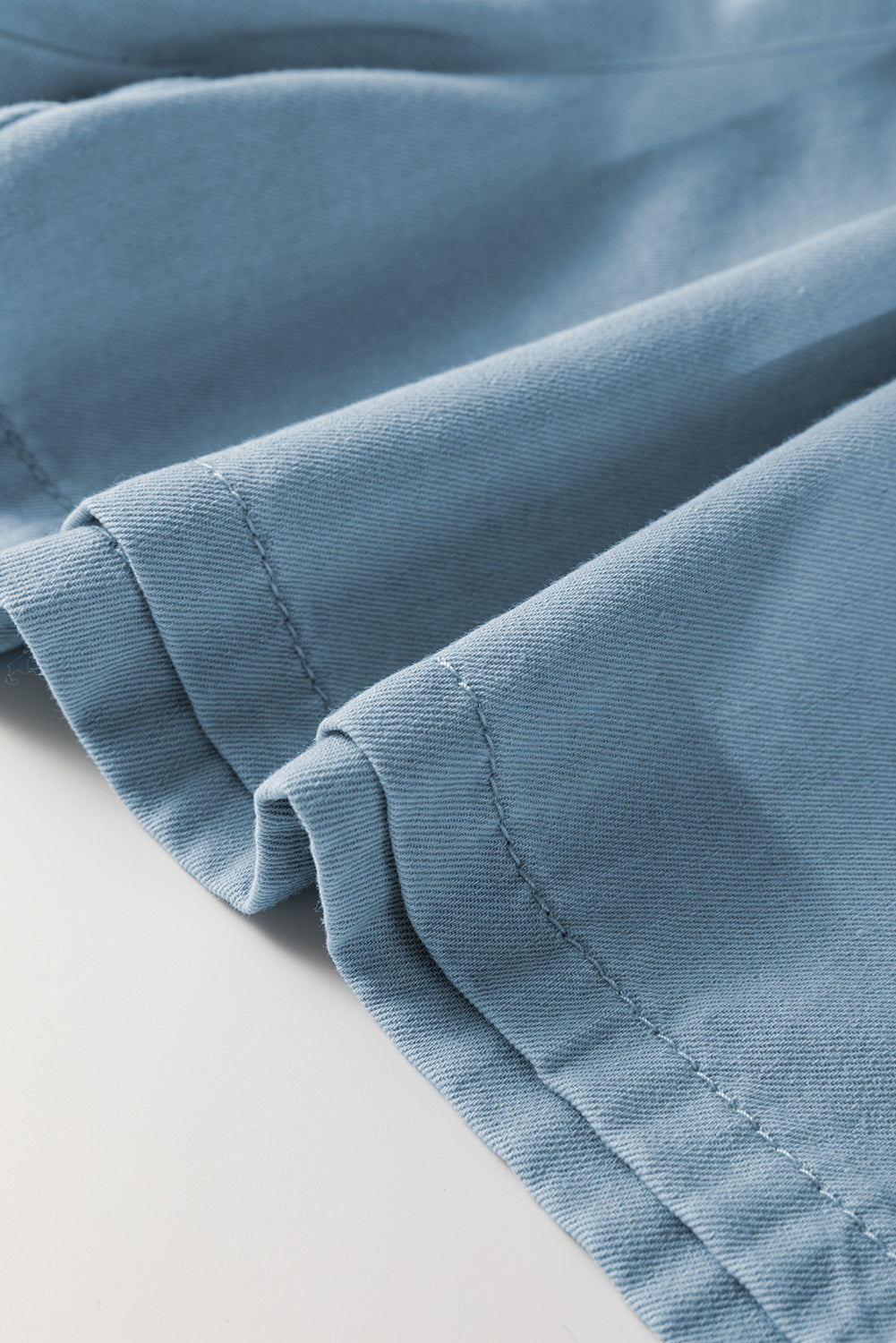 Close-up of blue fabric hem on elastic waist plus size summer shorts by kjplussizefashion