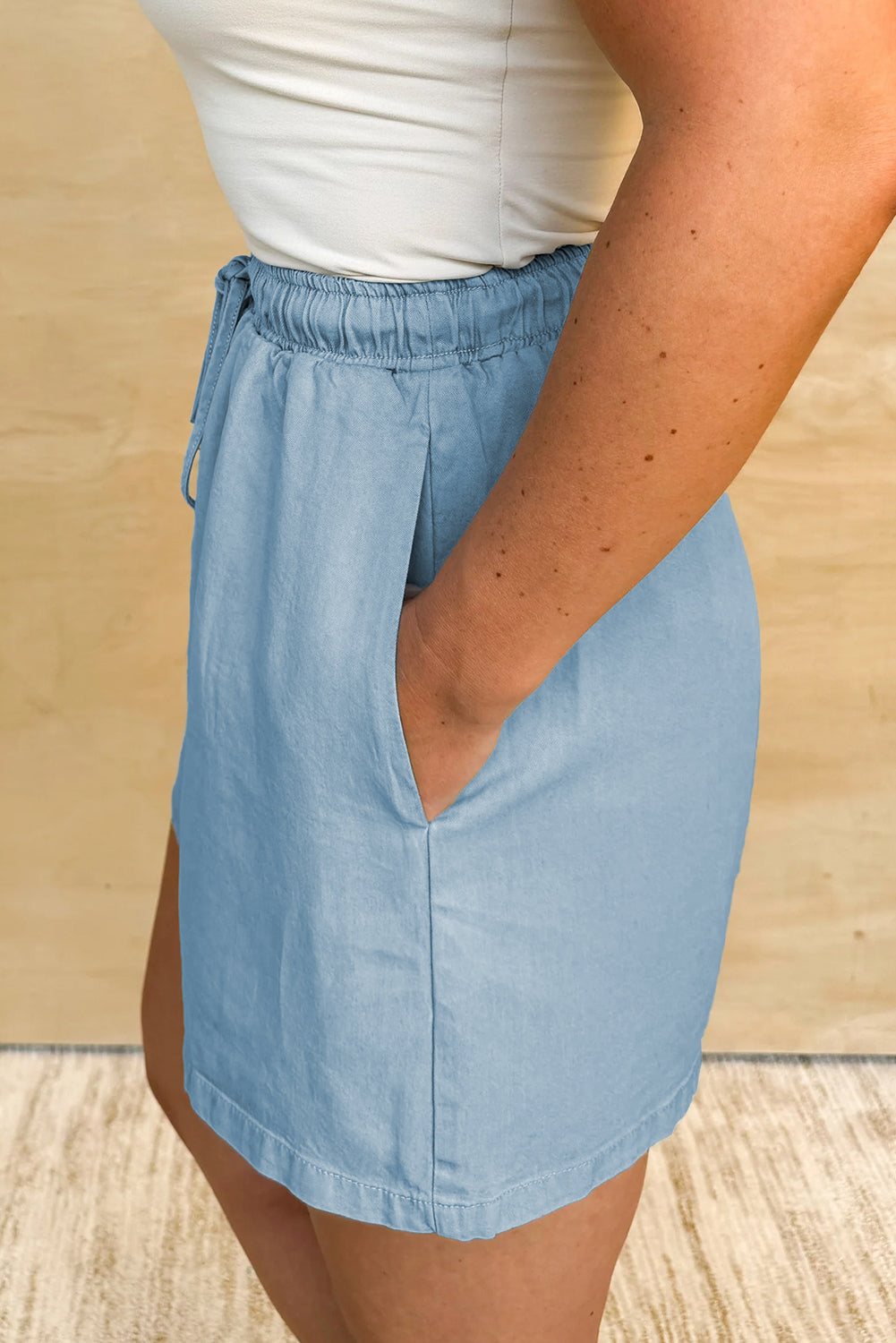 Light blue elastic waist plus size summer shorts with side pockets worn with a white top