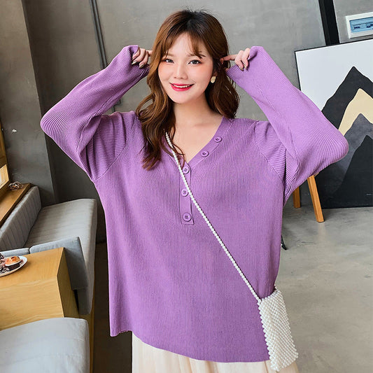 Woman wearing a purple button v-neck knit sweater for curvy women with long sleeves indoors