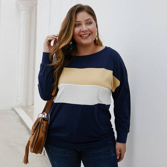 Smiling woman wearing casual plus size tops for women in navy blue with beige and white color blocks