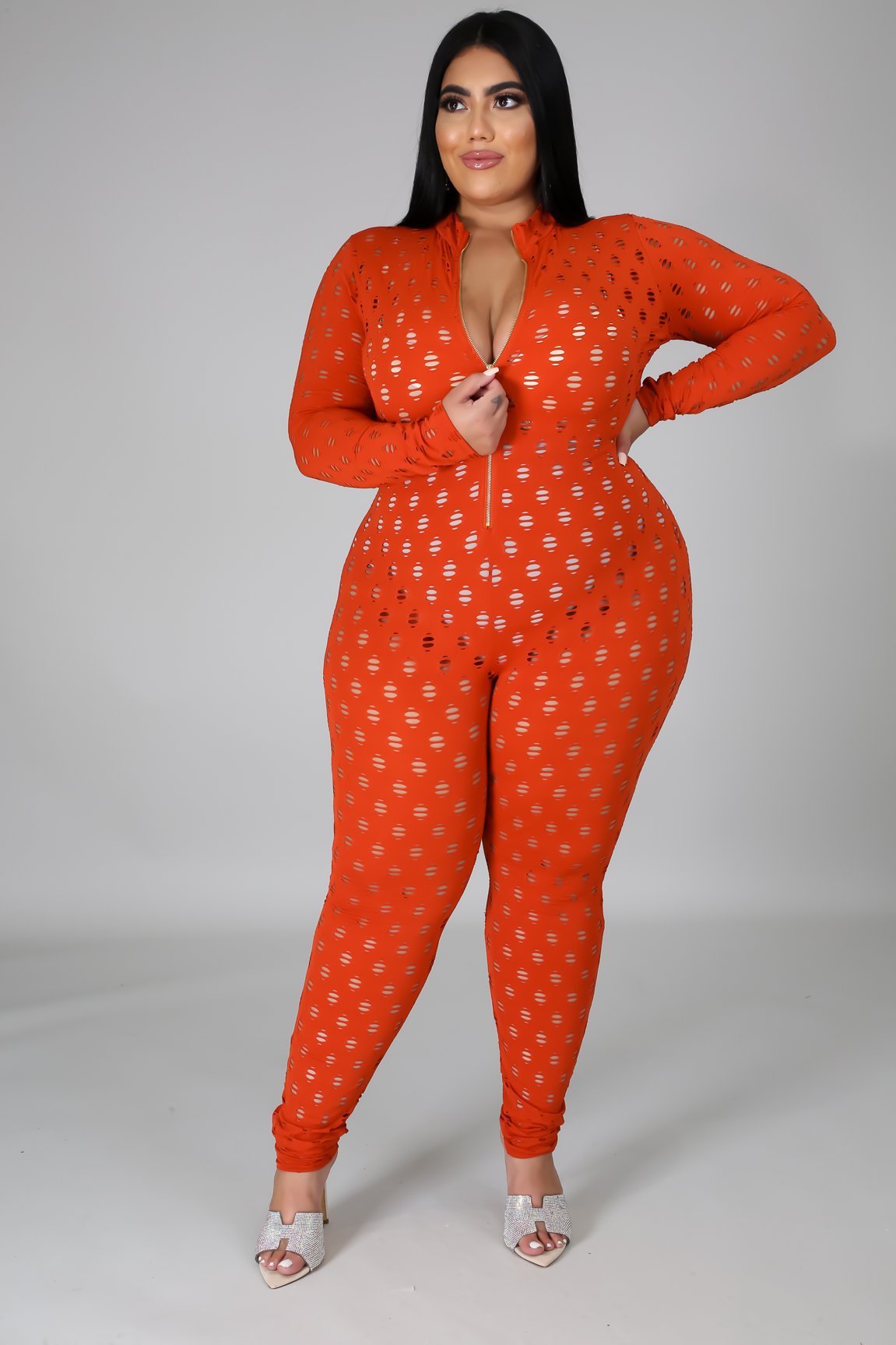 Curvy women zip front jumpsuit in orange with long sleeves and a fitted silhouette