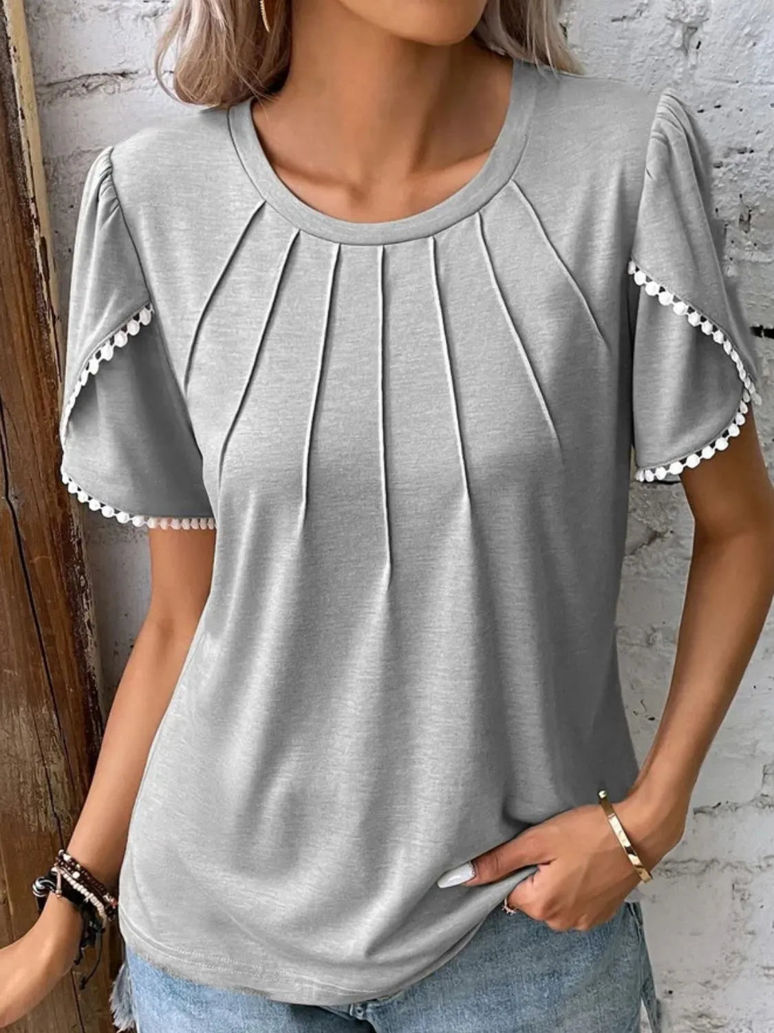 Light gray full size round neck top for women with pleated front and scalloped sleeve details