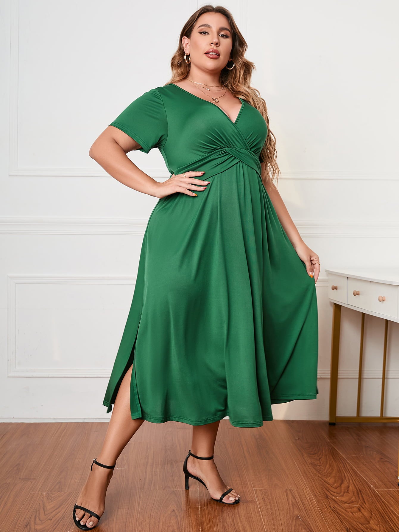 Green plus size short sleeve dress with V-neck and side slits worn by model