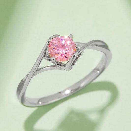 Elegant moissanite sterling silver ring with a round pink gemstone in a delicate twisted band design